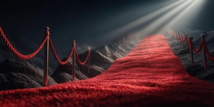 Red carpet leading to a spotlight in a dark atmosphere with ropes outlining the path photo