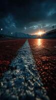 Sunset over the running track with mountains in the background during a stormy evening at the sports complex photo