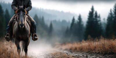 Horseback rider navigating a misty forest trail at dawn with rugged terrain and tall trees in the background photo