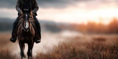 Rider on horseback traverses a serene landscape at dusk with warm colors illuminating the sky photo