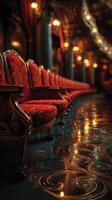 Elegant red chairs lined in an ornate hall reflecting warm light from vintage lamps photo