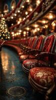Row of ornate red chairs in a warmly lit theater with festive decorations during the holiday season photo
