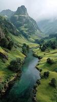 Lush green hills and a tranquil river in the misty mountains during early morning light photo