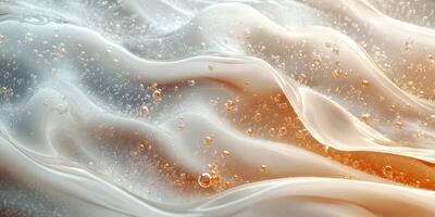 Waves of translucent liquid create bubbles with a soft orange glow in a mesmerizing display of movement and texture photo