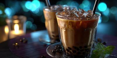 Refreshing bubble tea served in clear glasses with ice and black tapioca pearls during a relaxed evening setting photo