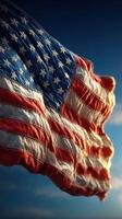 American flag waves proudly against a clear sky during sunset, showcasing its vibrant colors and intricate stitching photo