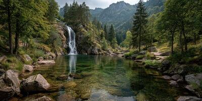 Waterfall cascading into a serene pool surrounded by lush forest and mountains in a tranquil natural setting photo