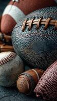 Sports equipment collection featuring various balls and gear arranged together on a textured surface in a dynamic display photo