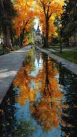 Vibrant autumn foliage reflects in a serene waterway beside an elegant building in a tranquil park setting photo
