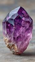 Beautiful amethyst crystal showcasing deep purple hues and natural formations on a smooth surface photo