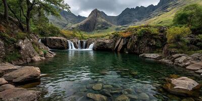 Majestic waterfall cascades into serene pool surrounded by lush mountains and rocky landscape in mid-afternoon light photo