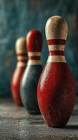 Vintage bowling pins lined up on a textured surface with a rustic background photo
