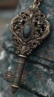 Intricate antique key resting on textured stone background, evoking history and mystery, perfect for collectors and enthusiasts of vintage artifacts photo