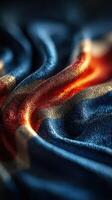 Textile showcasing vibrant blue, orange, and gold hues forming intricate patterns in soft fabric photo