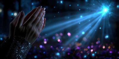 Hands lifted in appreciation during a captivating light display at a nighttime gathering, showcasing vibrant colors and glowing effects photo