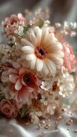 Beautiful bouquet of pastel flowers arranged elegantly on a soft fabric background during daylight photo