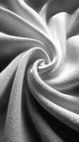 Elegant white fabric displays intricate textures and fluid patterns in soft lighting photo