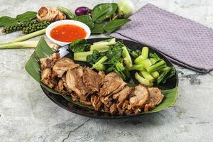 A plate of meat and vegetables with a napkin photo
