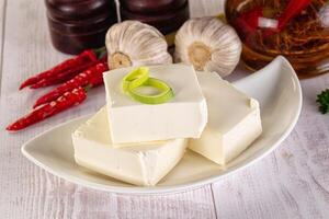 A white plate with three pieces of tofu photo