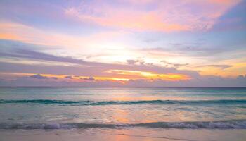 Sunset over a tranquil tropical beach with colorful sky reflections on calm waves photo