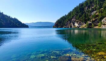 Serene lake surrounded by lush green mountains under a bright blue sky photo