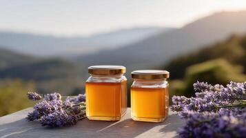 Glass jars of golden honey on a rustic wooden table with lavender sprigs, illuminated by warm sunset light photo