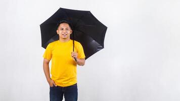 Portrait of smiling Asian man holding an umbrella isolated on white background photo