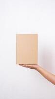 Close up of hand with package box parcel isolated on white background photo
