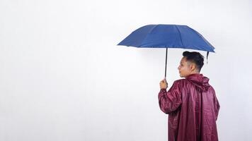 Asian man in red raincoat with umbrella isolated on white background photo