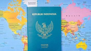 Yogyakarta, Indonesia, 2025 - Indonesian passport on world map background photo