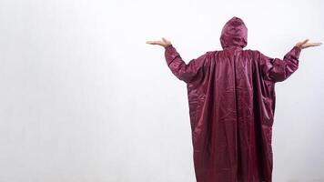 Rear view of man in red raincoat isolated on white background photo