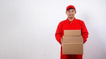 Asian Delivery man in red uniform with package boxes parcel isolated on white background photo