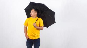 Asian man holds an umbrella isolated on white background photo