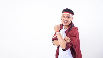 Indonesian man with red and white ribbon wristband showing spirit to celebrate independence day of Indonesia isolated on white background photo