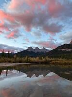 Beautiful Three Sister Mountains View point with Reflection on Lake at Sunrise, Canmore, Canada photo