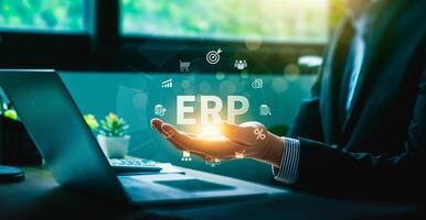 Businessman presenting ERP system with digital icons representing enterprise resource planning, finance, supply chain, analytics, and automation for business management and operational efficiency photo