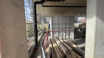 Construction Site with Container, Lumber, and Equipment photo