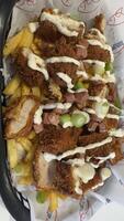 Fries Topped with Fried Chicken, Ham, and Sauce photo