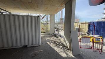 Construction Site with Storage Containers, Barriers, and Concrete Pillars photo