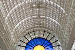 Interior View of Ceiling Structure with Stained Glass Window at Bentall Centre in Kingston, UK. photo