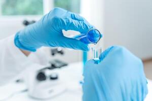 Scientist analyze biochemical, samples in advanced scientific laboratory. Research and development staff use dropper mix microbiological developmental of perfume. Biotechnology research in science lab photo