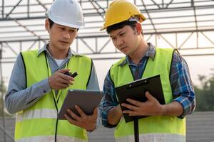 Engineers use tablet and check the blueprint on site. Contractor and inspector inspection construction during project.civil Forman check quality assurance. Audit, inspect, quality control. photo