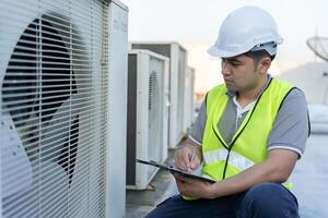 engineer works on the roof of factory. contractor inspect compressor system and plans installation of air condition systems in construction. Checklist, inspector, control photo