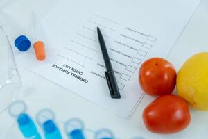 check list for chemical food residues in laboratory. Control experts inspect quality of fruits, vegetables. lab, find prohibited substances, contaminate, Microscope, Microbiologist photo