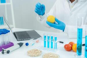 Scientist check chemical food residues in laboratory. Control experts inspect quality of vegetables vegetables. lab, hazards, find prohibited substances photo