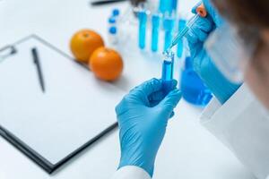 Scientist check fruit in laboratory. Control experts inspect the concentration of chemical residues. hazards, standard, find prohibited substances, contaminate, Microbiologist photo