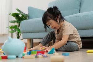 Happy Asian child play and learn toy blocks. children are very happy and excited at home. child have a great time playing, activities, development, attention deficit hyperactivity disorder photo