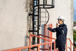 maintenance and inspector. Maintenance engineers are using walky talky to inform the results of inspection of buildings and structures. Irrigation engineers are exploring sluice system photo