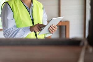 engineer is inspec construction house using a tablet. Engineers and architects or contactor count materials for construction. Building, check, insurance house, quality, foreman. photo