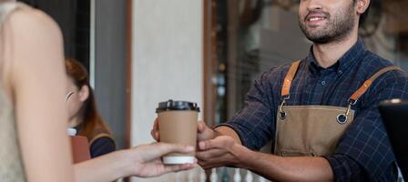 owner happy the pass on coffee in first day of small business cafe. guarantees safety, cleanliness, open the coffee shop. New normal. SME, welcome, restaurant, home made photo